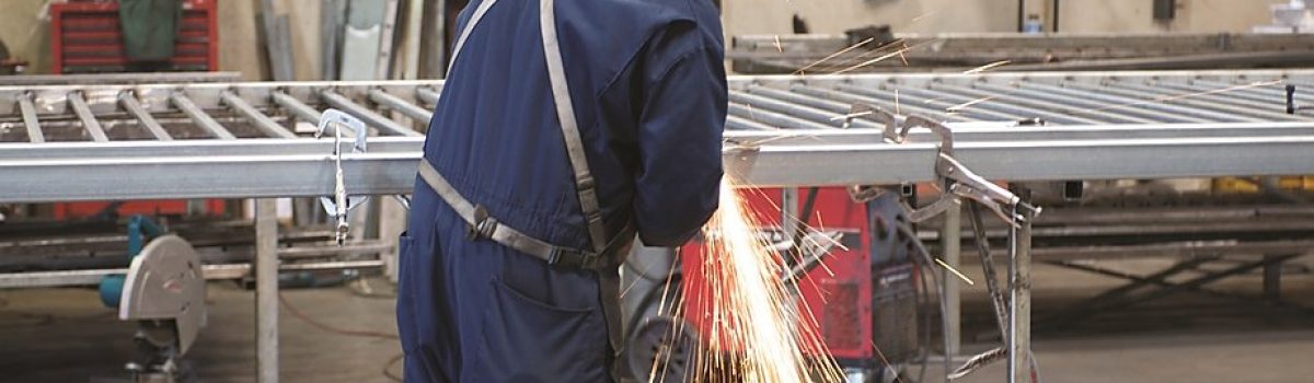 Man welding steel for fencing